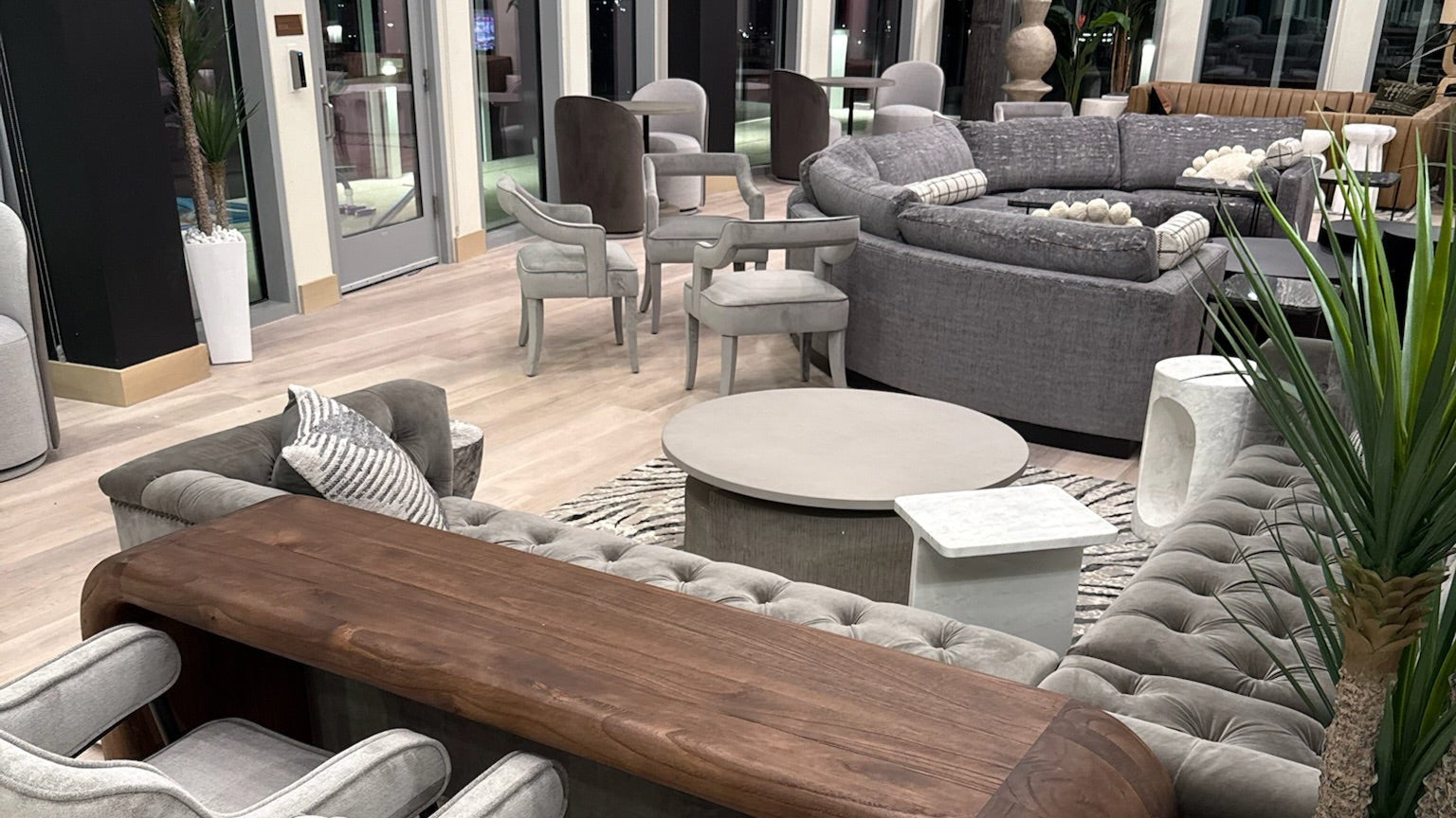 The 29th Floor of The Icon in Austin Texas features modern indoor setting with gray furniture, wooden dining table, and plants.